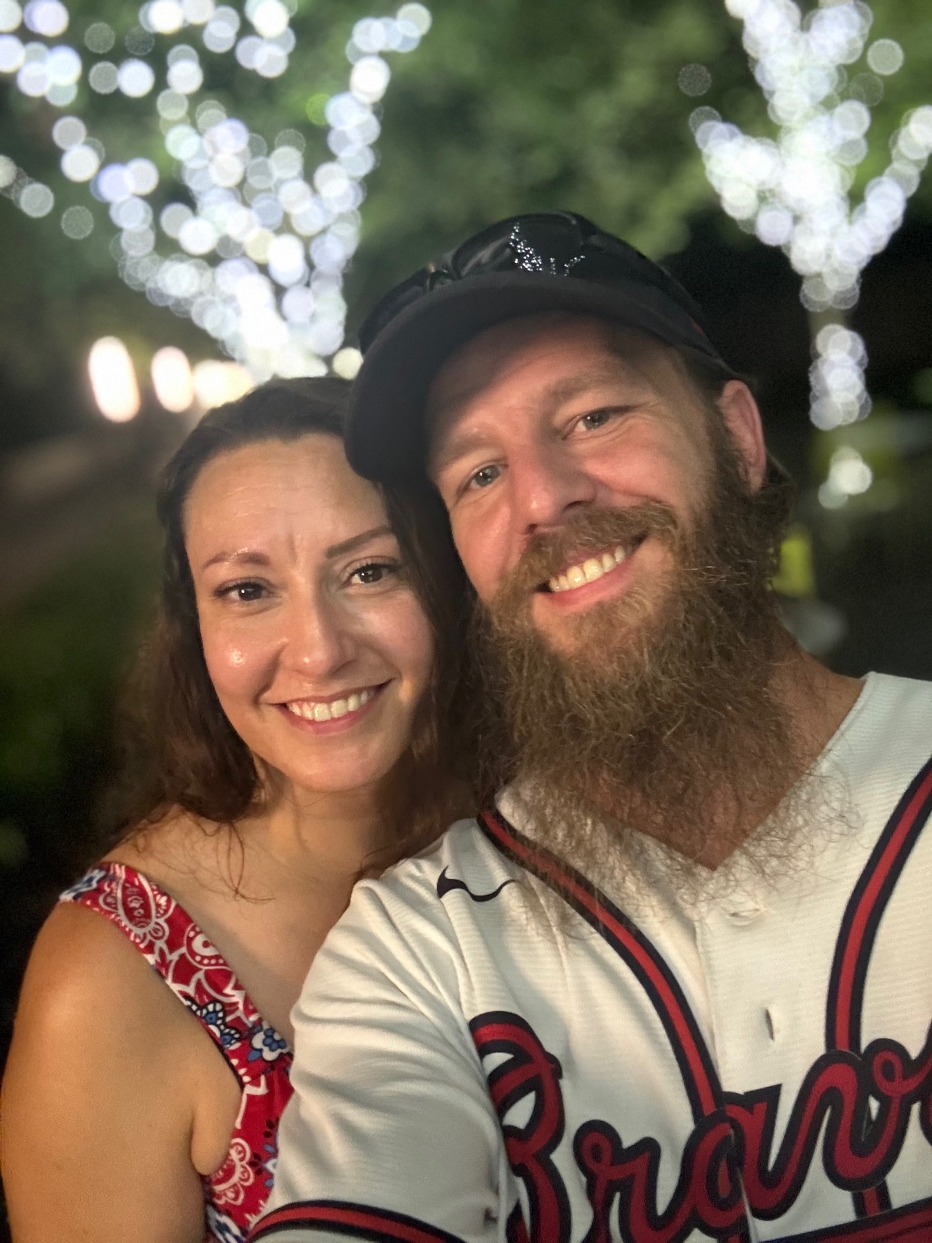 Jessica and Kenneth smiling under soft evening lights