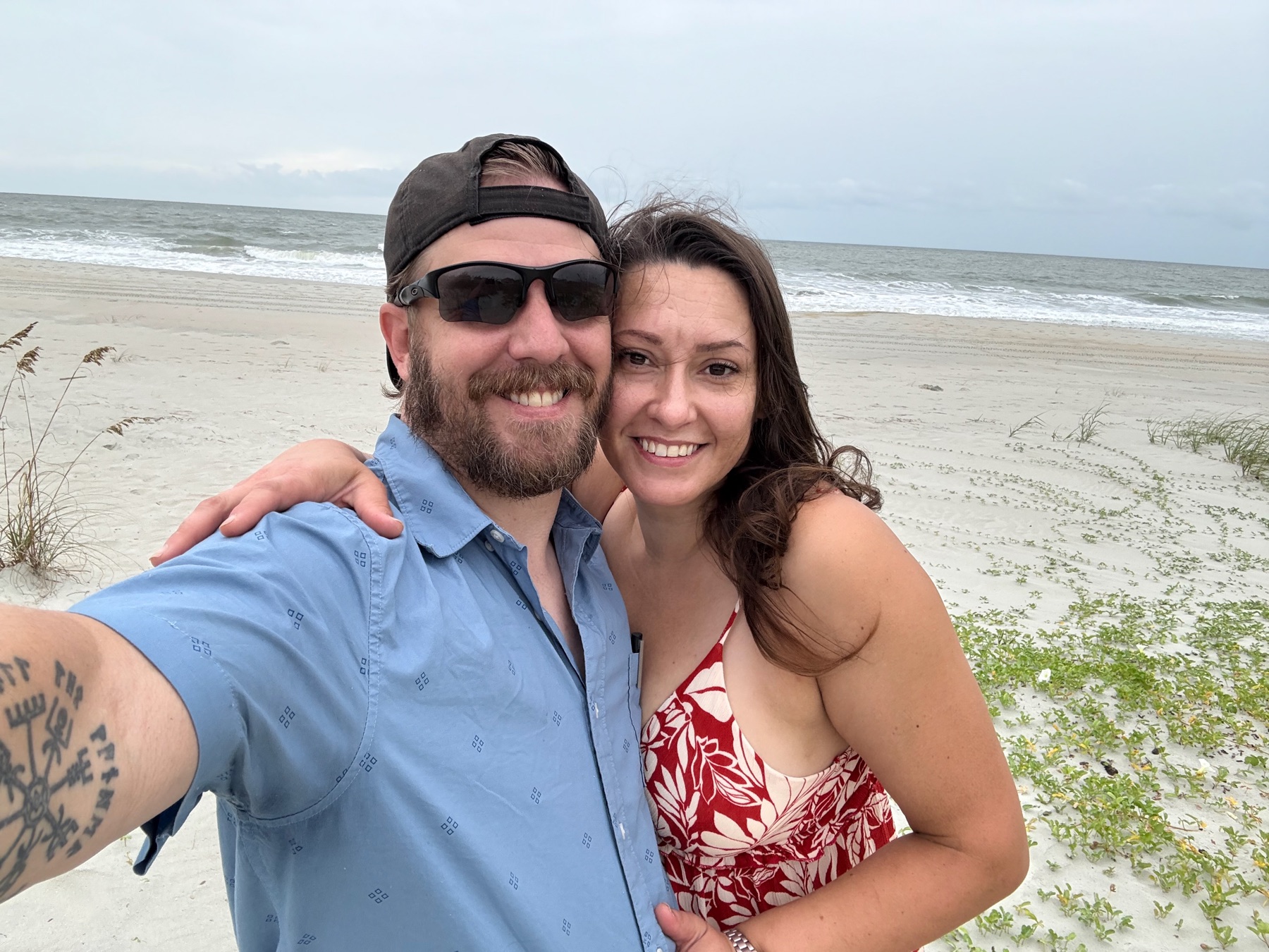 Jessica and Kenneth smiling together at the beach